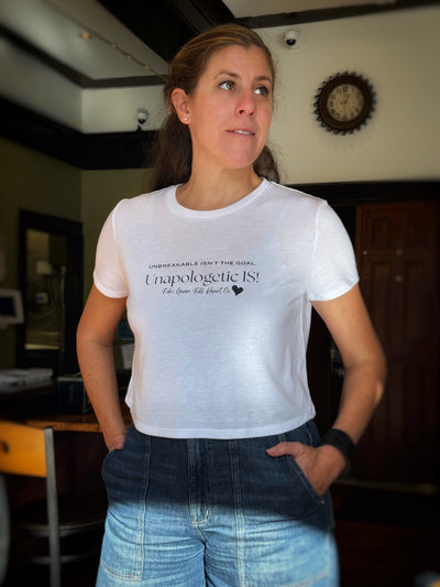 Women’s Flowy Cropped Graphic Tee – Unbreakable Isn’t the Goal, Unapologetic Is